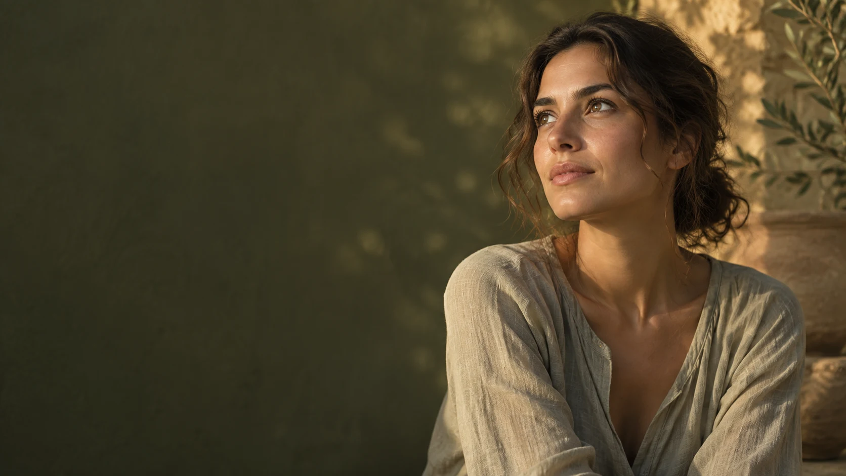 A young woman looking thoughtfully towards the light