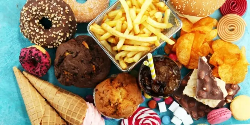 Unhealthy foods high in sugar and dairy—common acne causes that natural acne treatment aims to eliminate for clearer skin.