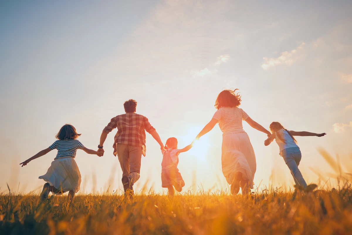 Family running hand-in-hand at sunset—protecting kids from colds and flu at home