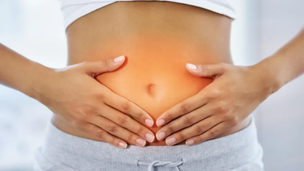 Hands on abdomen highlighting gut health—linked to skin flare-ups through the gut-skin connection