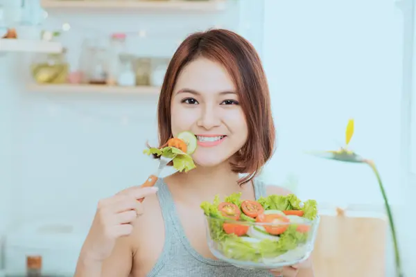 Woman eating—food choices can influence eczema flare-ups for some people