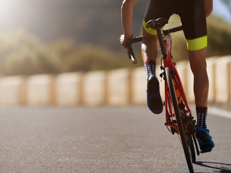Cyclist riding through the desert landscape in Dubai