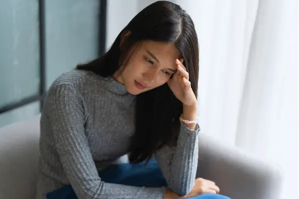 Woman feeling stressed—emotional triggers can worsen eczema flare-ups